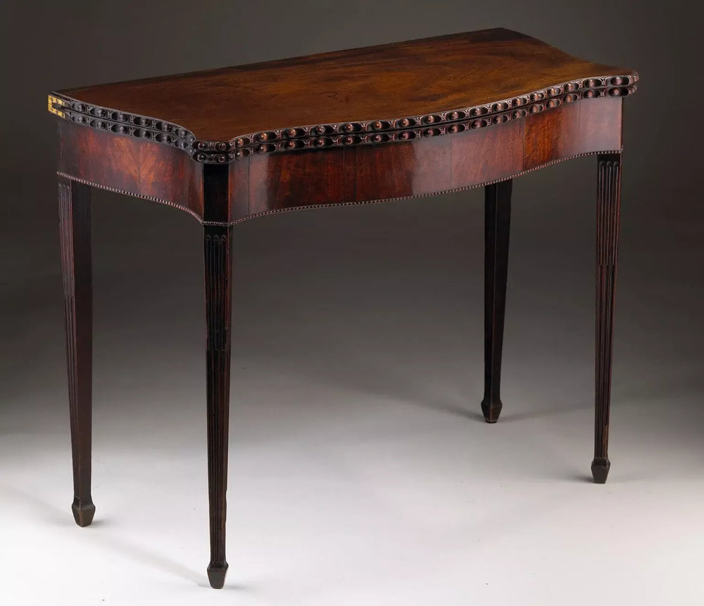 George III Serpentine Mahogany Card Table with fluted legs, serpentine front, and egg-and-dart moulded top circa 1760.