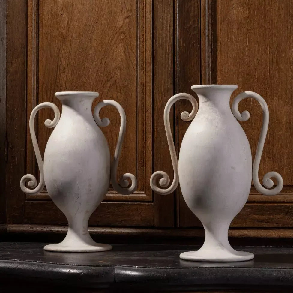 A pair of painted wood lamp bases by Andrew Allfree, 20th century, with elegant curved handles.