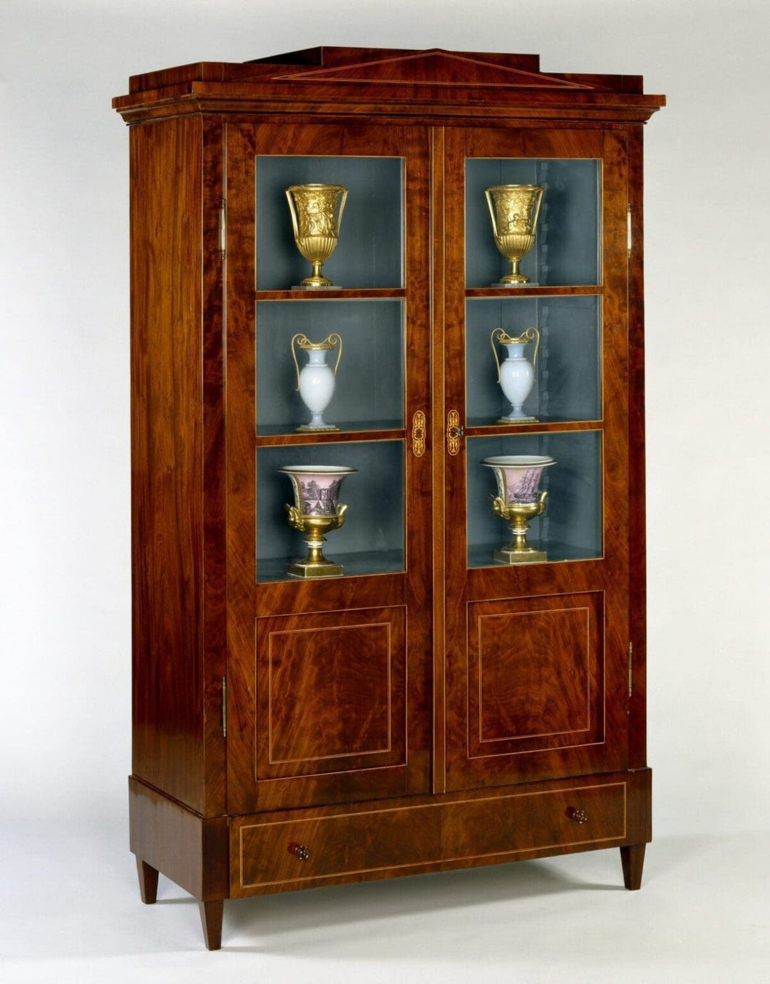 Early 19th Century Berlin Mahogany Armoire with glazed doors and flame mahogany veneer display cabinet circa 1825.