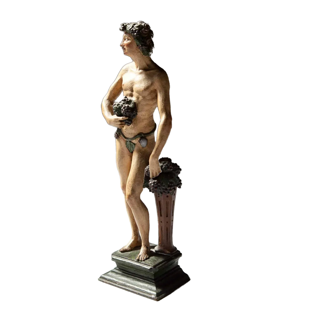 Flemish Carved Wooden Polychrome Figure Of Bacchus, 17th century sculpture of Roman god holding grapes on plinth.
