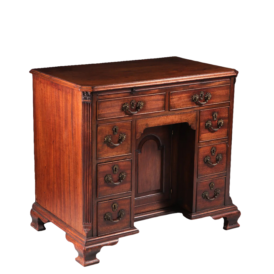 GEORGE II MAHOGANY KNEEHOLE DESK with brass handles, recessed cupboard, ogee bracket feet, 18th-century English design.