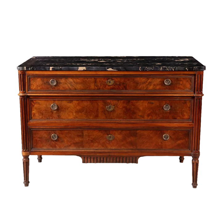 A French provincial Louis XVI commode with burr walnut veneer, fluted legs, and Nero Portoro marble top, stamped COURTE.