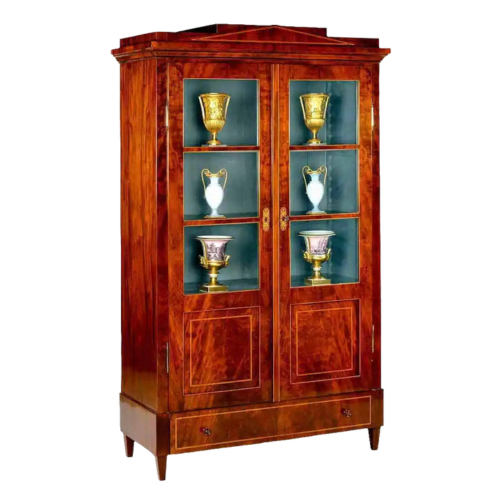 Early 19th Century Berlin Mahogany Armoire with glazed doors, flame veneer, marquetry escutcheons, and painted interior.