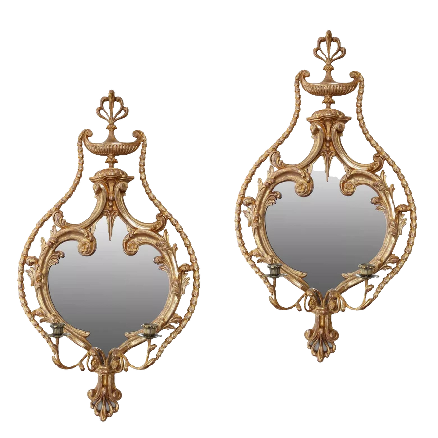 A fine pair of giltwood girandoles, English, 19th Century, in the manner of William France with ornate carvings and mirrors.