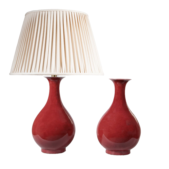 Pair of Meiping Sang de Boeuf Table Lamps with deep red glaze porcelain vases, one with cream pleated lampshade.
