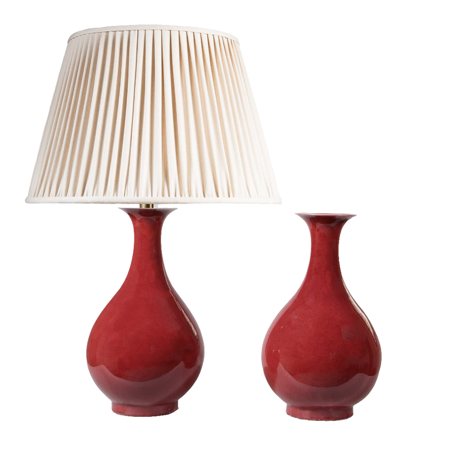 Pair of Meiping Sang de Boeuf Table Lamps with deep red glaze porcelain vases, one with cream pleated lampshade.