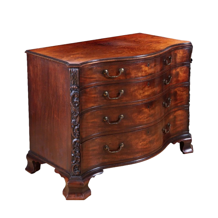 George III Chippendale Mahogany Serpentine Commode with four oak drawers and carved fruiting vine pilasters.