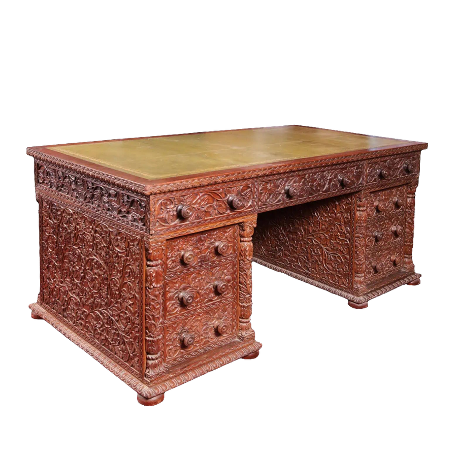 Anglo Indian Teak Pedestal Desk with intricate carved vines, leaves, and fruit, featuring green tooled leather top.