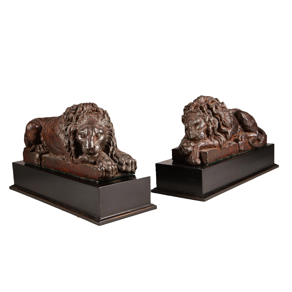 Pair of Cast Iron Versions of the Canova Lions depicting sleeping and vigilant lions on black bases circa 1820.