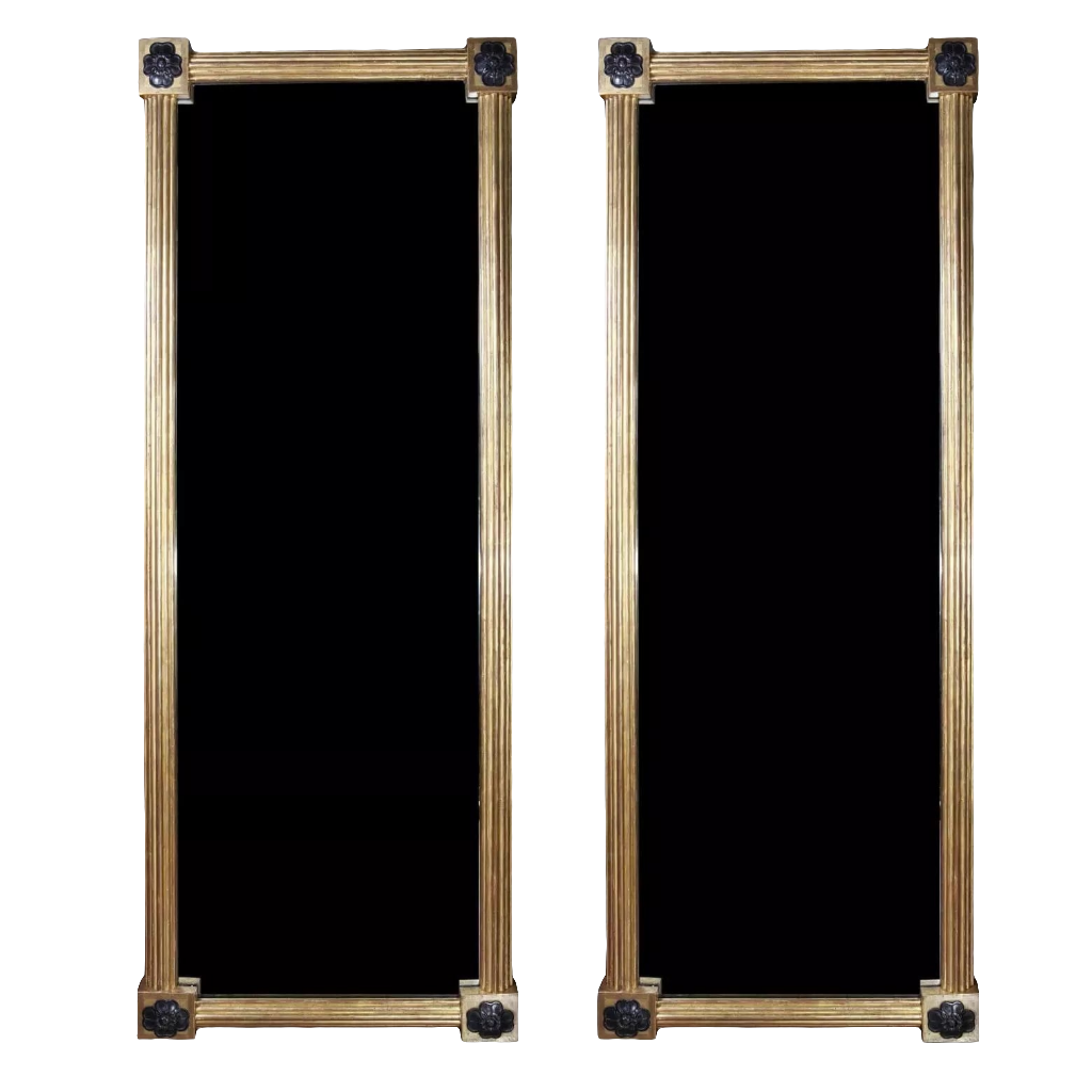 Pair of Tall Regency Giltwood Pier Mirrors with reeded frames and floral corner details, England circa 1850.