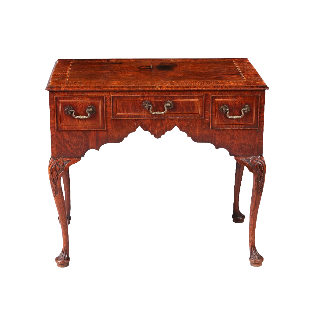 GEORGE II OAK LOW BOY with quarter veneered top, three drawers, sculptural ogee detailing, and cabriole legs circa 1735.