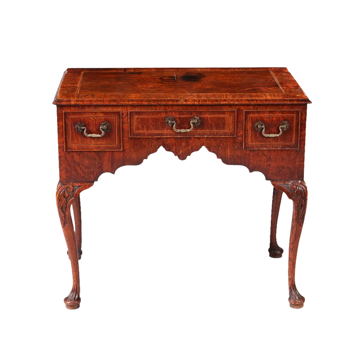 GEORGE II OAK LOW BOY with quarter veneered top, three drawers, sculptural ogee detailing, and cabriole legs circa 1735.