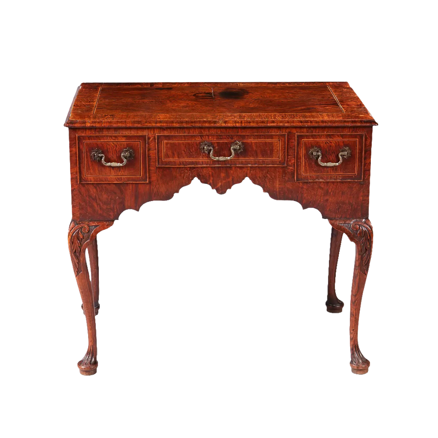 GEORGE II OAK LOW BOY with quarter veneered top, three drawers, sculptural ogee detailing, and cabriole legs circa 1735.