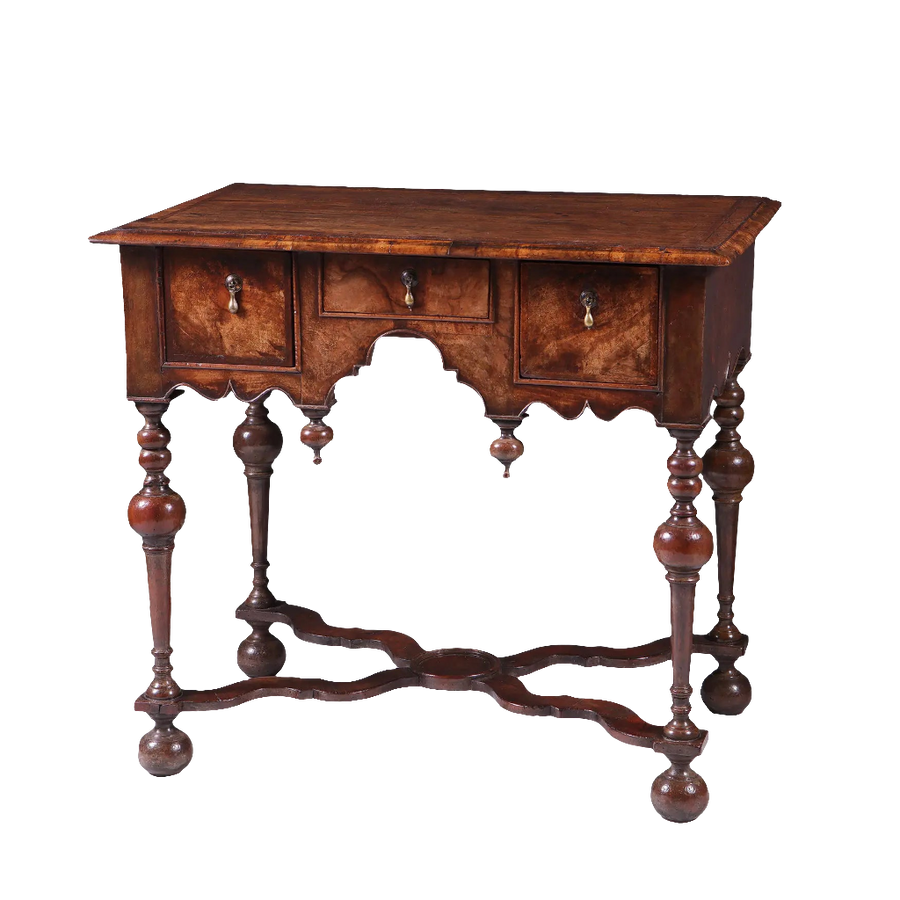GEORGE I WALNUT LOW BOY with three drawers, Dutch gable aprons, lathe turned legs, and bun feet, early 18th century style.