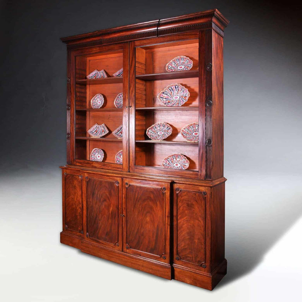 George III Chippendale period mahogany breakfront bookcase with glazed doors and carved details, circa 1780.