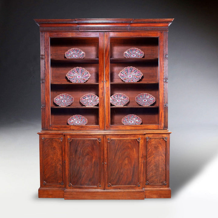 George III Chippendale period mahogany breakfront bookcase with carved cornice and glazed doors circa 1780.
