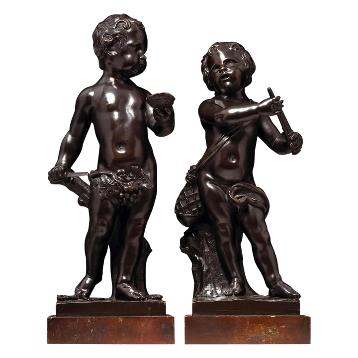 A Pair Of Bronze Cherubs On Marble Bases, 18th-century Flemish sculptures of cherubs with musical and oyster shell details.