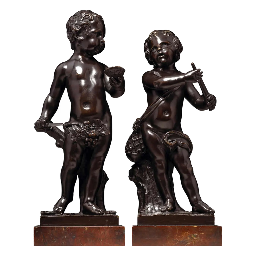 A Pair Of Bronze Cherubs On Marble Bases, 18th-century Flemish sculptures of cherubs with musical and oyster shell details.