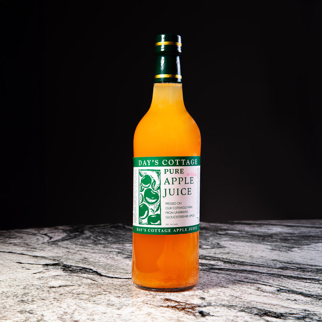 Day’s Cottage pure apple juice bottle on marble surface, featured in Nicholas Wells Antiques Christmas Hamper 2025.