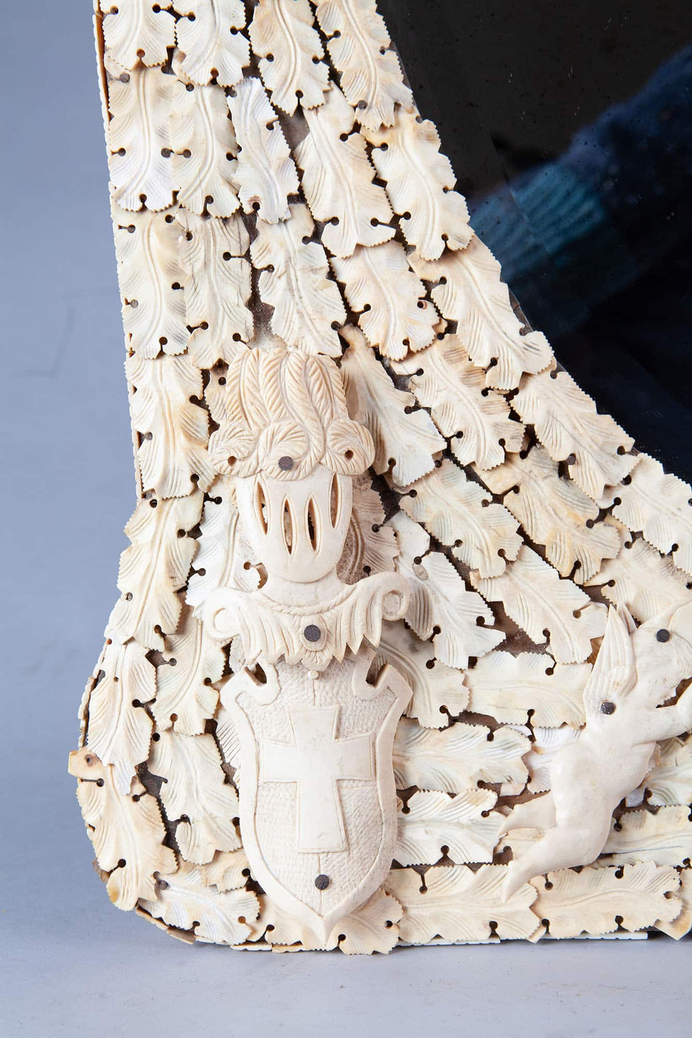Dieppe Bone Mirror close-up showing intricate carved overlapping bone slices with shield and cherub details.