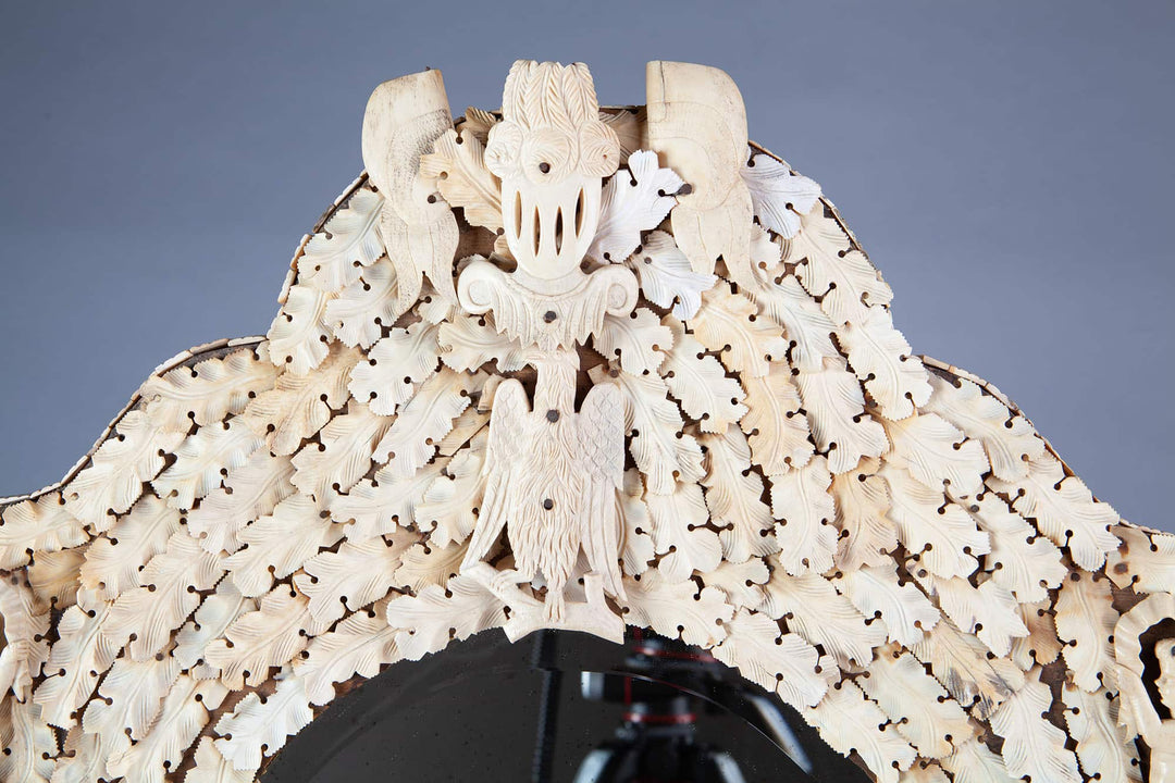Dieppe Bone Mirror with intricate carved whale bone featuring musical cherubs, knights, and flags, circa 1830, France.