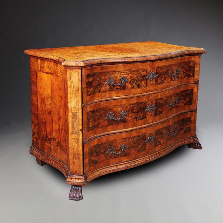 Early 18th Century Italian Walnut Commode with three drawers, parquetry top, rococo handles, and carved paw feet circa 1740.