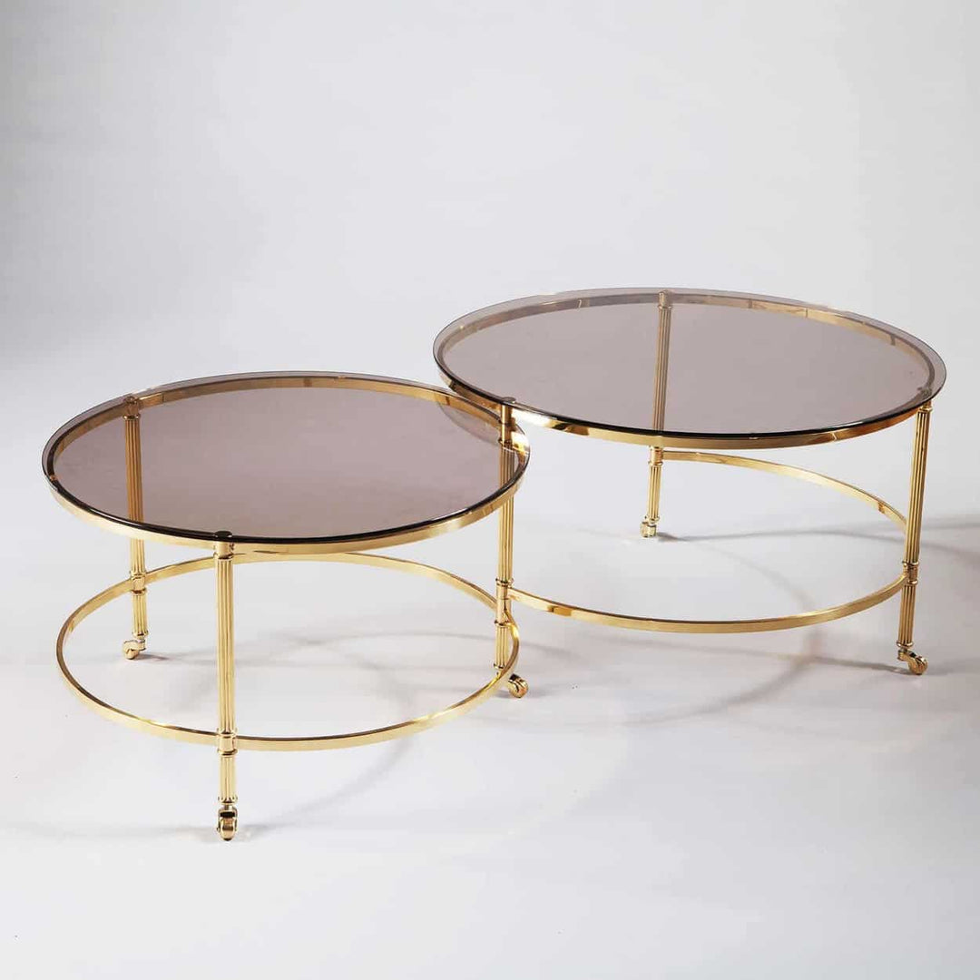 Mid Century Metamorphic Brass Coffee Table with burnished brass frame, smoked glass tops, and rolling second tier extension.