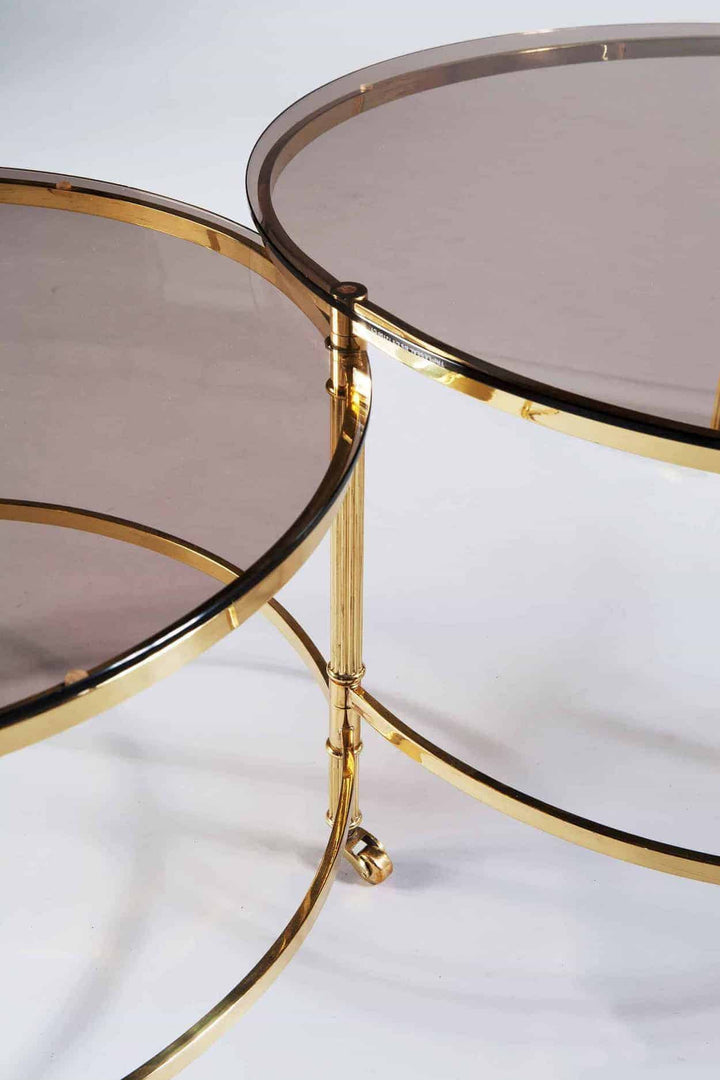 Mid Century Metamorphic Brass Coffee Table with smoked glass tops and burnished brass frame on casters.
