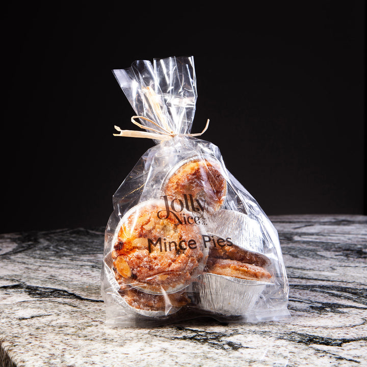 Clear bag of Jolly Nice mince pies on a stone surface, part of Nicholas Wells Antiques Christmas Hamper 2025 collection