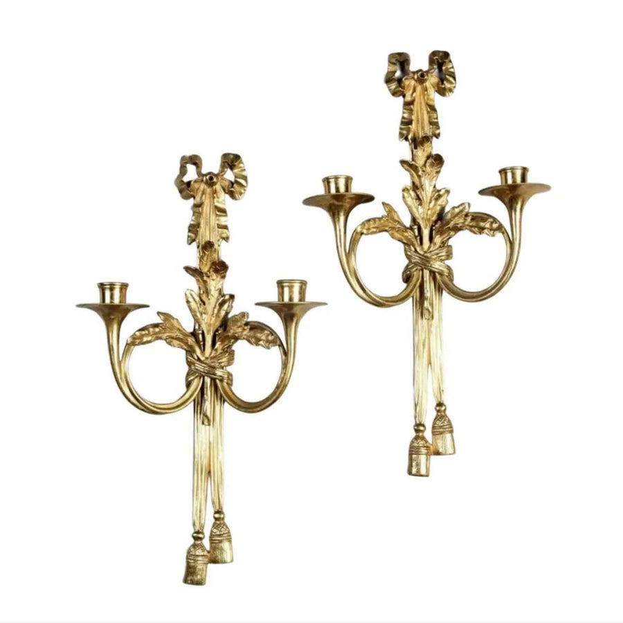 Pair of Louis XVI style gilt-bronze wall lights with French horn arms, oak leaf and ribbon motifs, circa 1950.