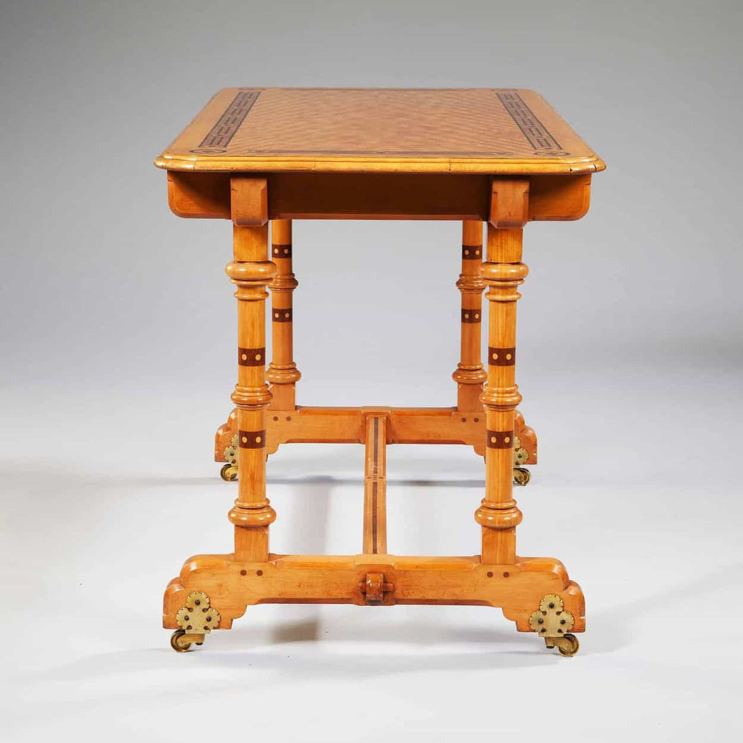 Arts And Crafts Writing Table By Marsh And Jones made of satinwood with foliate inlays and brass casters, circa 1900.