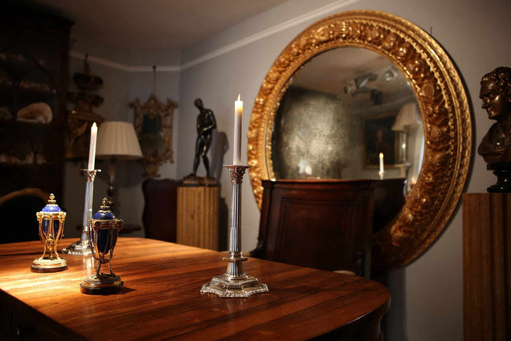 Monumental 5ft Round Italian Mirror with gilded carved frame featuring fruits and foliage in an elegant room setting.