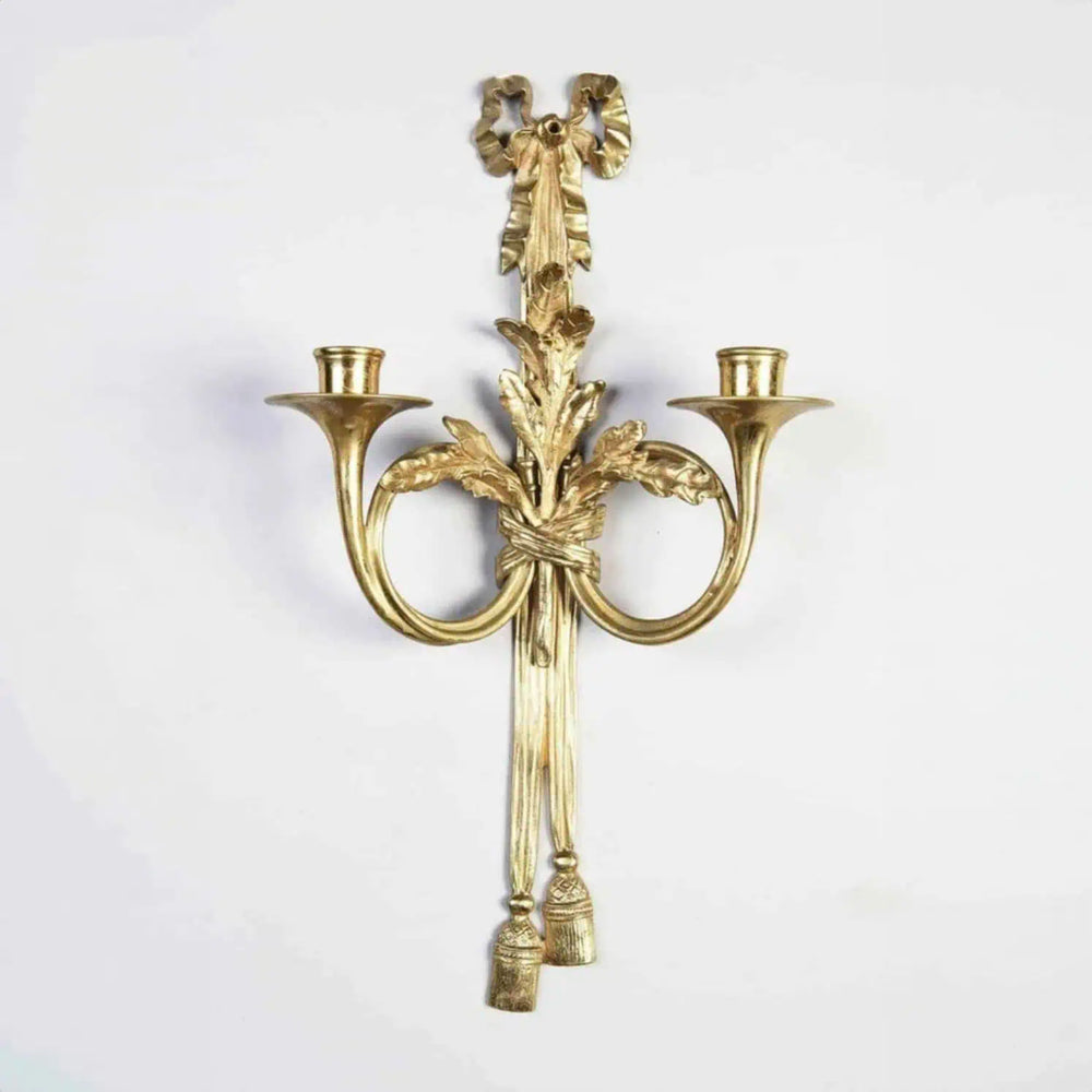Pair of Louis XVI style gilt-bronze wall lights with two arms shaped as French horns and oak leaf decor.
